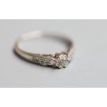 A modern 18ct white metal and diamond cluster ring, with diamond set shoulders, size O, gross 2.5