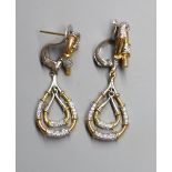 A modern pair of yellow and white metal, diamond chip set pear shaped graduated double drop