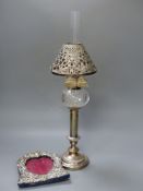 A Victorian plated oil lamp with white metal shade together with a Victorian silver mounted frame