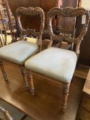 A set of four early Victorian carved rosewood dining chairs