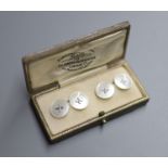 A pair of white metal mounted mother of pearl circular cufflinks, in Goldsmiths and Silversmiths