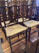 A set of four George III country oak rush seated chairs, with shaped back splat, turned supports and