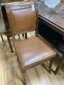 A set of six Empire style brass mounted mahogany dining chairs with tan leather upholstery