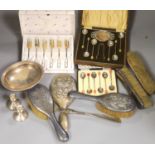 A matched seven piece silver mounted brush set, nine items of silver flatware, a silver bowl, pair