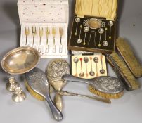 A matched seven piece silver mounted brush set, nine items of silver flatware, a silver bowl, pair