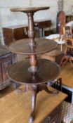 A 19th century mahogany three tier circular dumb waiter, with dish top on tripod base, height 106cm