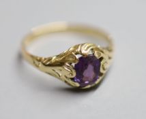 A yellow metal and purple sapphire set ring, with GCS report dated 8/3/2021, stating the cushion cut