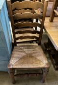 A set of six oak rush seated ladderback dining chairs