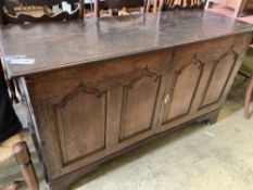 A mid 18th century oak two door cupboard, (converted from a coffer), width 144cm, depth 50cm, height