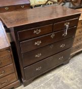 A George II provincial oak chest of two short and three long drawers, with brass drop handles and