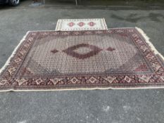 A Chinese Tabriz style carpet having burgundy central medallion on a foliate ivory ground, 338 x