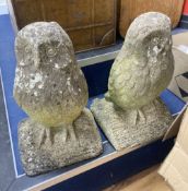 A pair of reconstituted stone owl garden ornaments, height 46cm