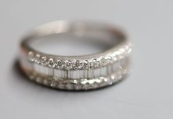 A modern 18k, baguette and round brilliant cut diamond set three row half eternity ring by Butani,