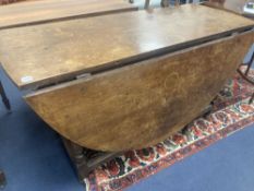 An 18th century oak gateleg dining table, width 173cm, depth 142cm, height 76cm