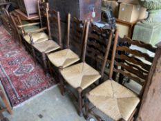 A harlequin set of seven oak and beech rush seated, ladder back dining chairs