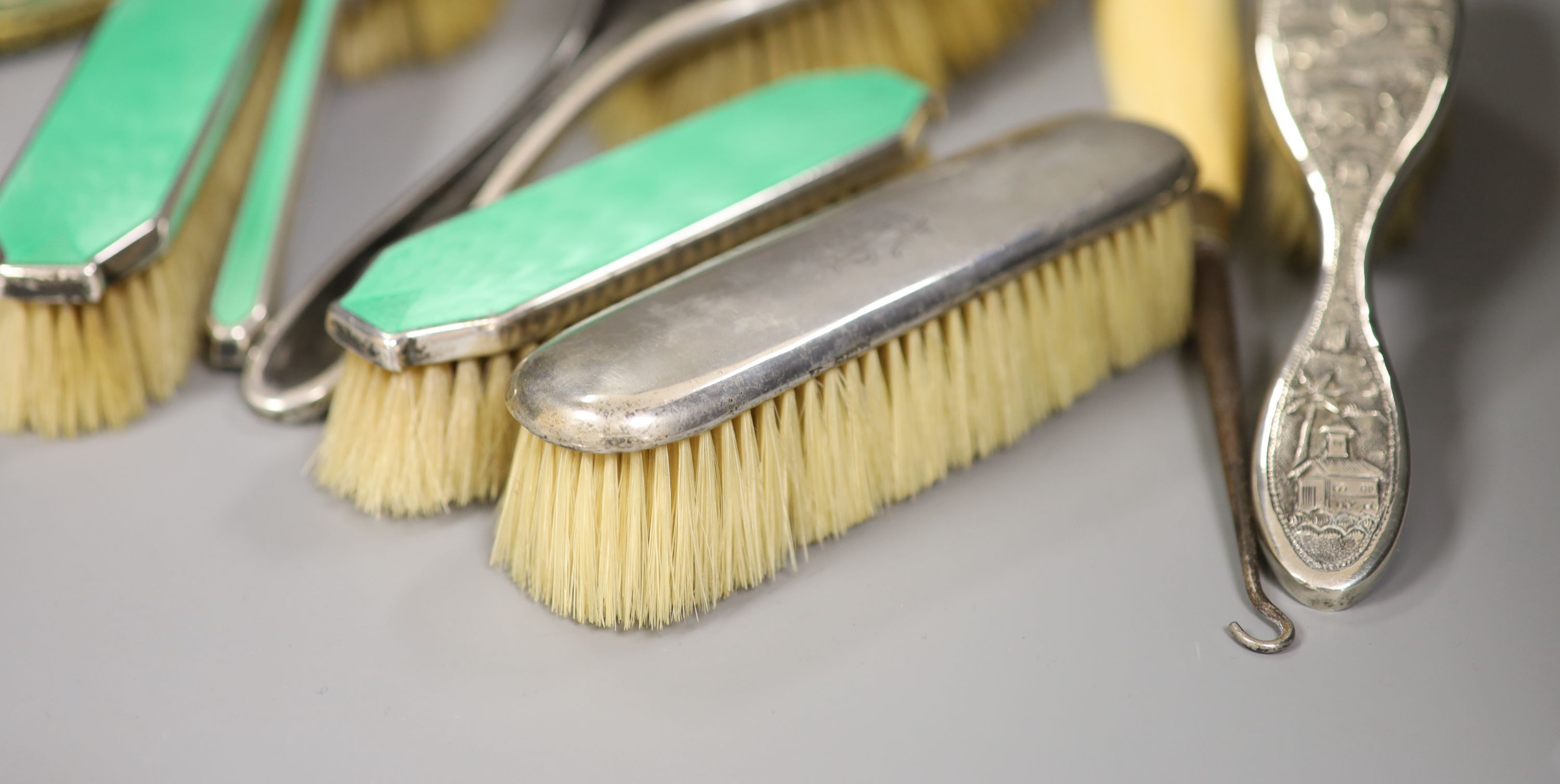 A guilloche enamel and silver-mounted three-piece brush and comb set, three other silver-mounted - Image 3 of 4