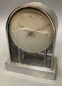 A chrome electric mantel clock with arched case, height 20cm