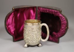 A cased Victorian embossed silver christening cup, Charles Boyton II, London, 1887, 93mm, 4oz.