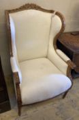 An upholstered wing armchair, width 70cm, depth 70cm, height 110cm
