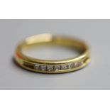 A modern 18ct gold and channel set eight stone diamond ring, size N/O, gross 4.4 grams.CONDITION: