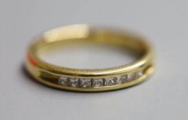 A modern 18ct gold and channel set eight stone diamond ring, size N/O, gross 4.4 grams.CONDITION: