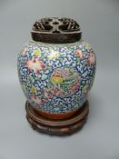 A 19th century Chinese enamelled jar with carved wood cover and stand, overall height 26cm