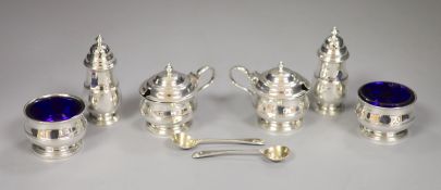 A George V silver six piece condiment set, with blue glass liners, Adie Brothers, Birmingham, 1927/