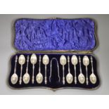 A late Victorian cased set of twelve silver apostle teaspoons and tongs, William Hutton & Sons,