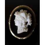 A Victorian gilt metal mounted composition glass? oval cameo brooch, carved with bust of a lady to