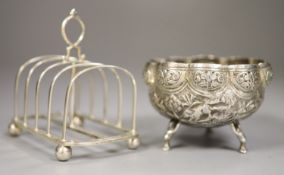 A George VI silver toastrack, Sheffield 1938, length 11.5cm and an Indian cusped white metal sugar