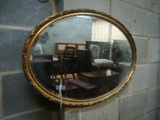 A gilt framed oval mirror