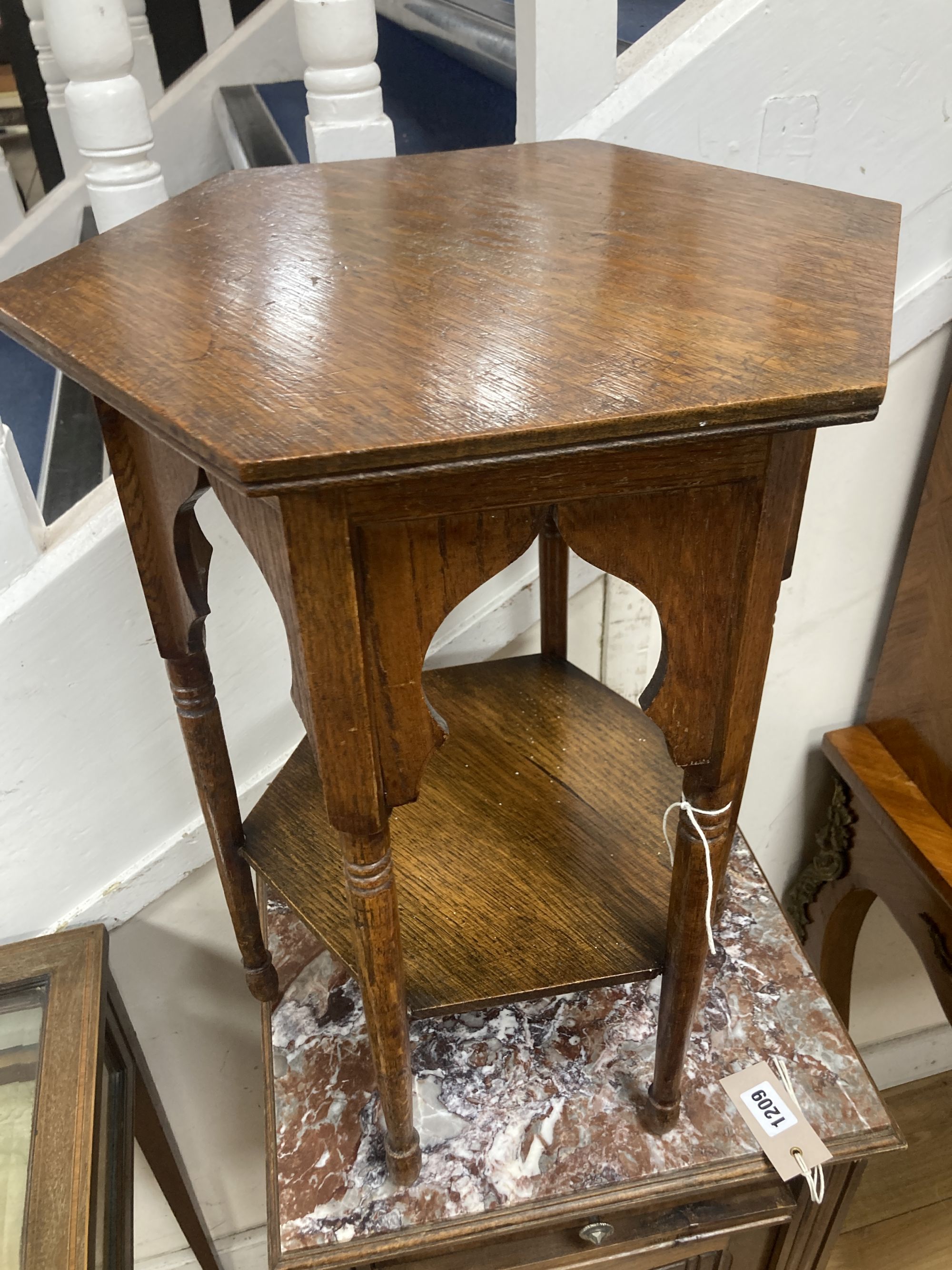 An early 20th century Moorish style hexagonal oak occasional table, width 36cm, height 51cm