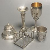 A Chinese white metal tot with applied dragon, 5cm, a 1920's small silver toastrack, a silver