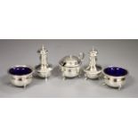 A George V silver three piece condiment set, T.H. Hazlewood & Co, Birmingham, 1918 with blue glass