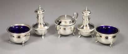 A George V silver three piece condiment set, T.H. Hazlewood & Co, Birmingham, 1918 with blue glass