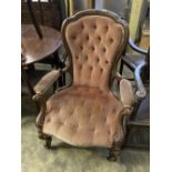 A Victorian carved walnut upholstered spoon back armchair, width 75cm, depth 70cm, height 102cm