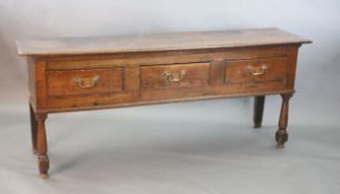 A mid 18th century oak three drawer low dresser, raised on turned baluster legs, length 185cm, width