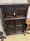 A 17th century style oak cupboard, width 100cm depth 42cm height 140cm