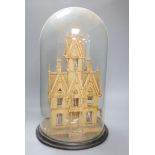A 19th century carved cork house under glass dome