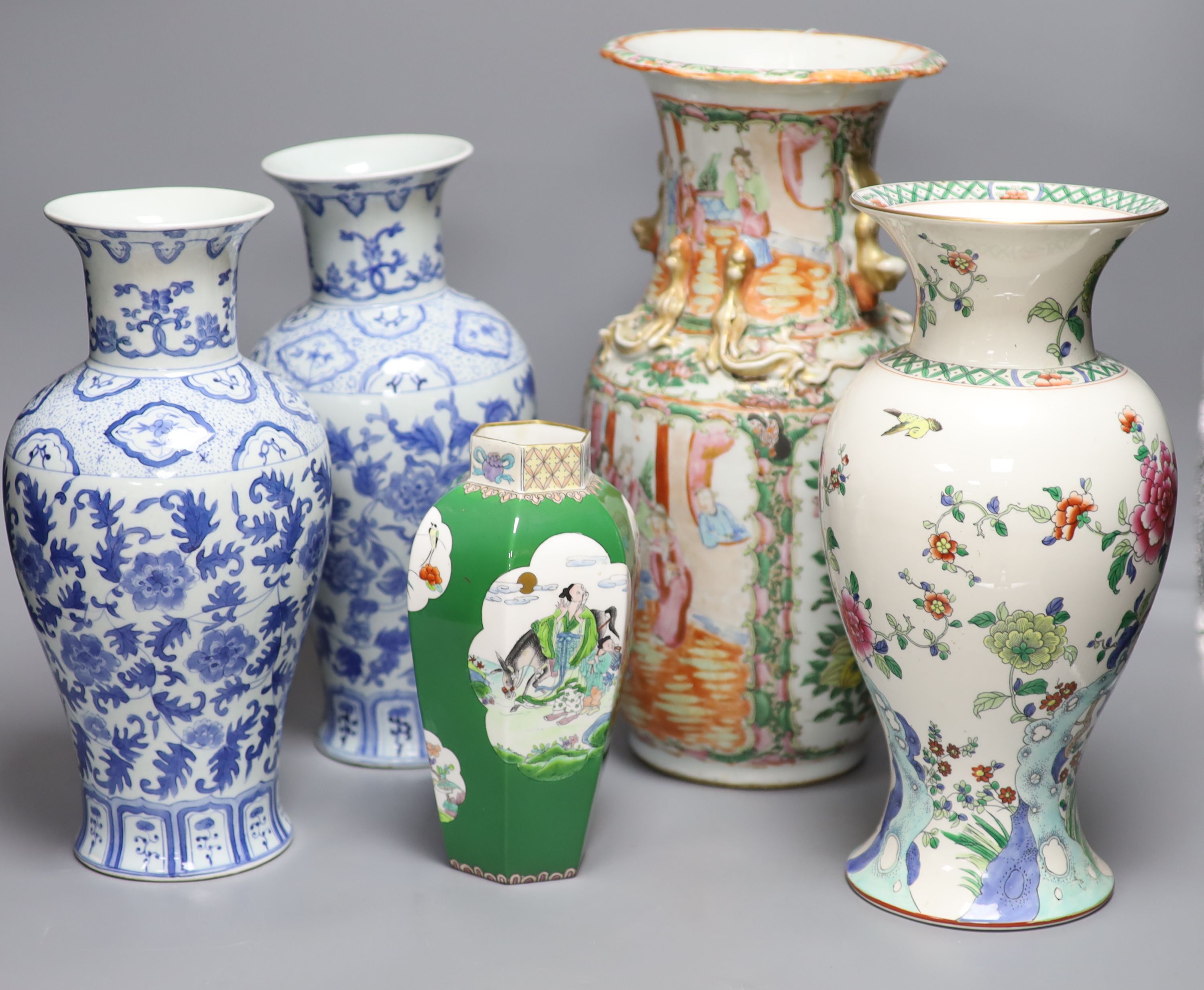 A Chinese famille rose Canton vase, a pair of blue and white vases and two others, tallest 35.