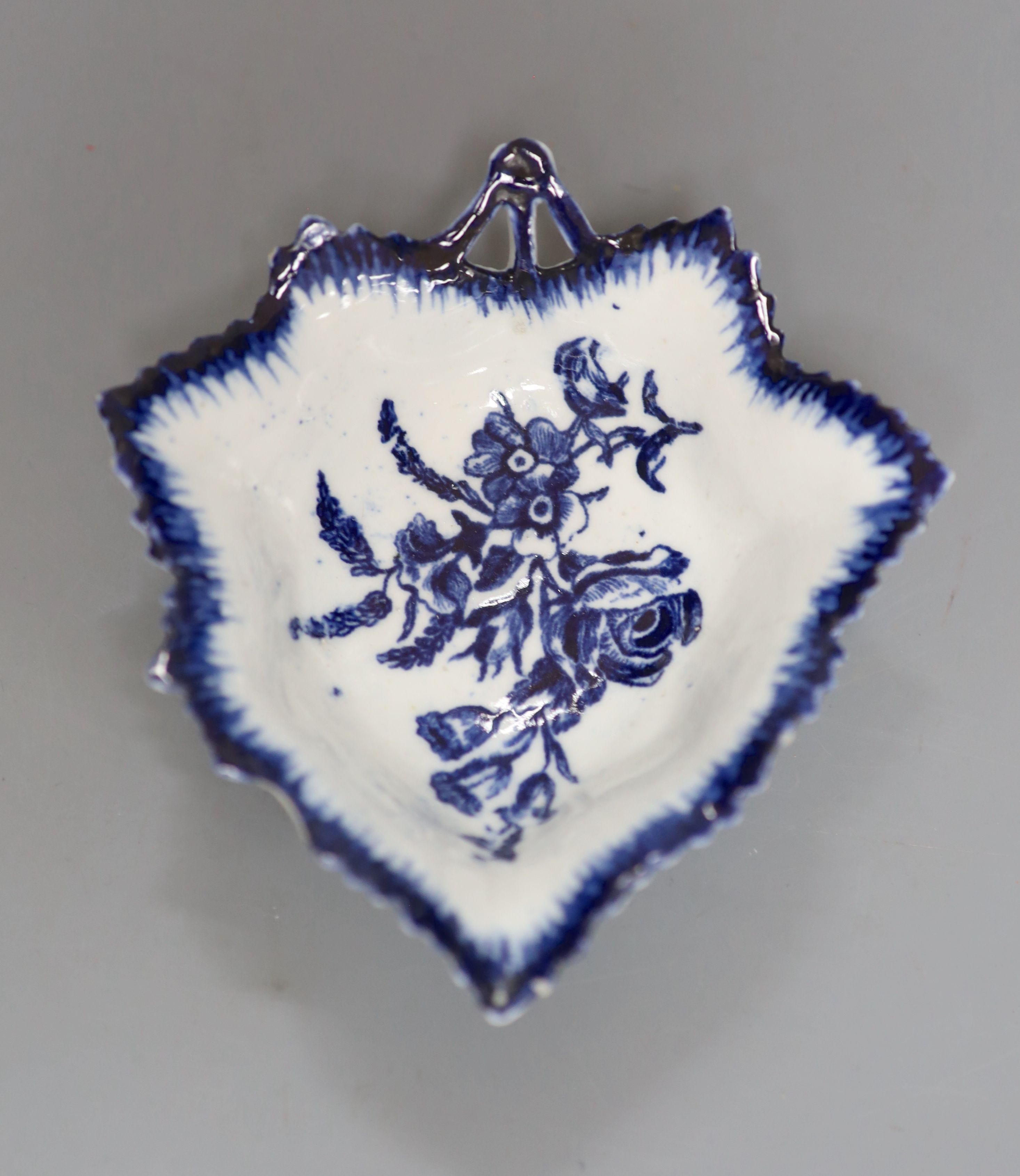 An 18th century Derby leaf shaped pickle dish decorated with flowers, in blue under a feather edge