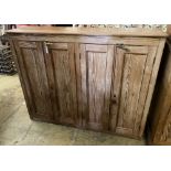 A Victorian pitch pine four door cabinet, width 146cm, depth 38cm, height 116cm