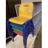A set of four metal and ply child's stacking chairs