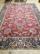 A Kashan burgundy ground carpet, 344 x 250cm