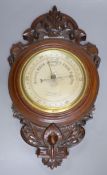 James Lucking & Co. A carved mahogany aneroid barometer, length 46cm