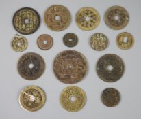 China, 15 cast bronze charms or amulets, Qing dynasty, four with multiple characters obverse and