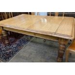 An early 20th century carved oak extending dining table, 294cm extended (three spare leaves), width