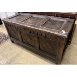 An 18th century oak coffer, later carved, width 135cm, depth 59cm, height 64cm