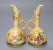 A pair of Royal Worcester blush ivory ewers painted and gilded with flowers, green mark, date code