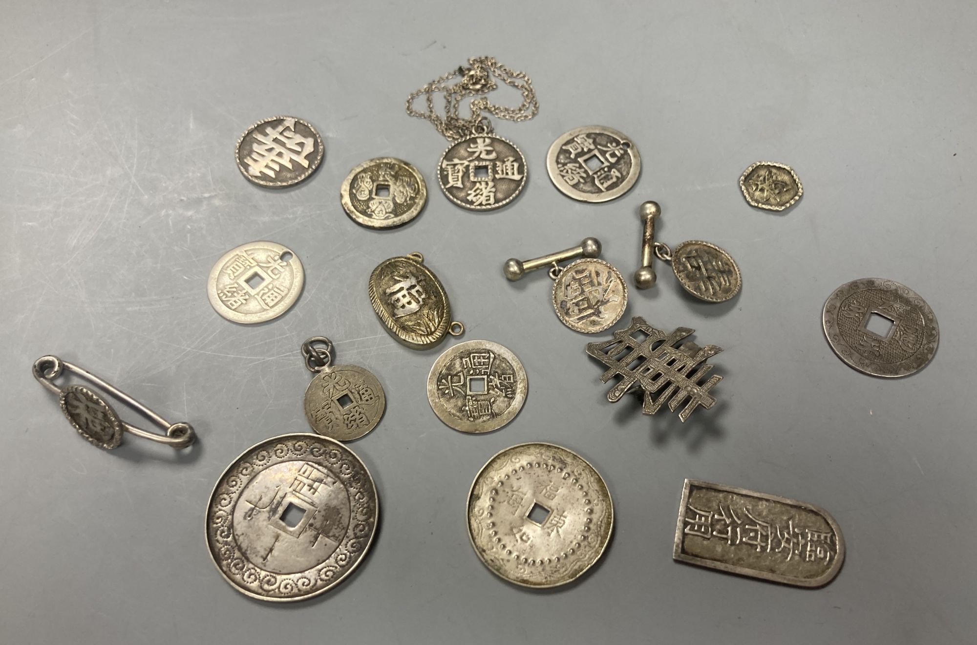 China, a group of silver and white metal coin charms, brooches and cuff links, Guangxu to Republic